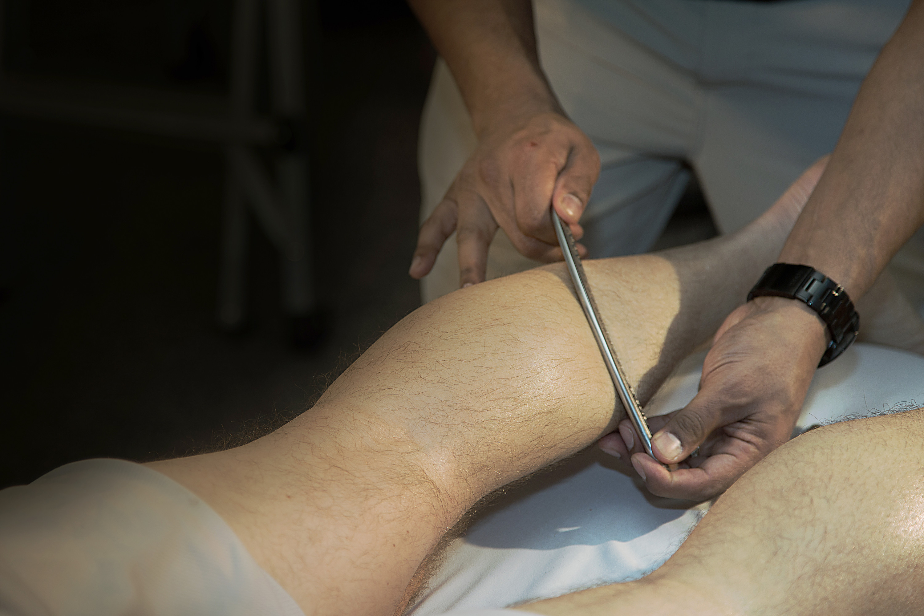 Athletic Therapist working on a patient's leg